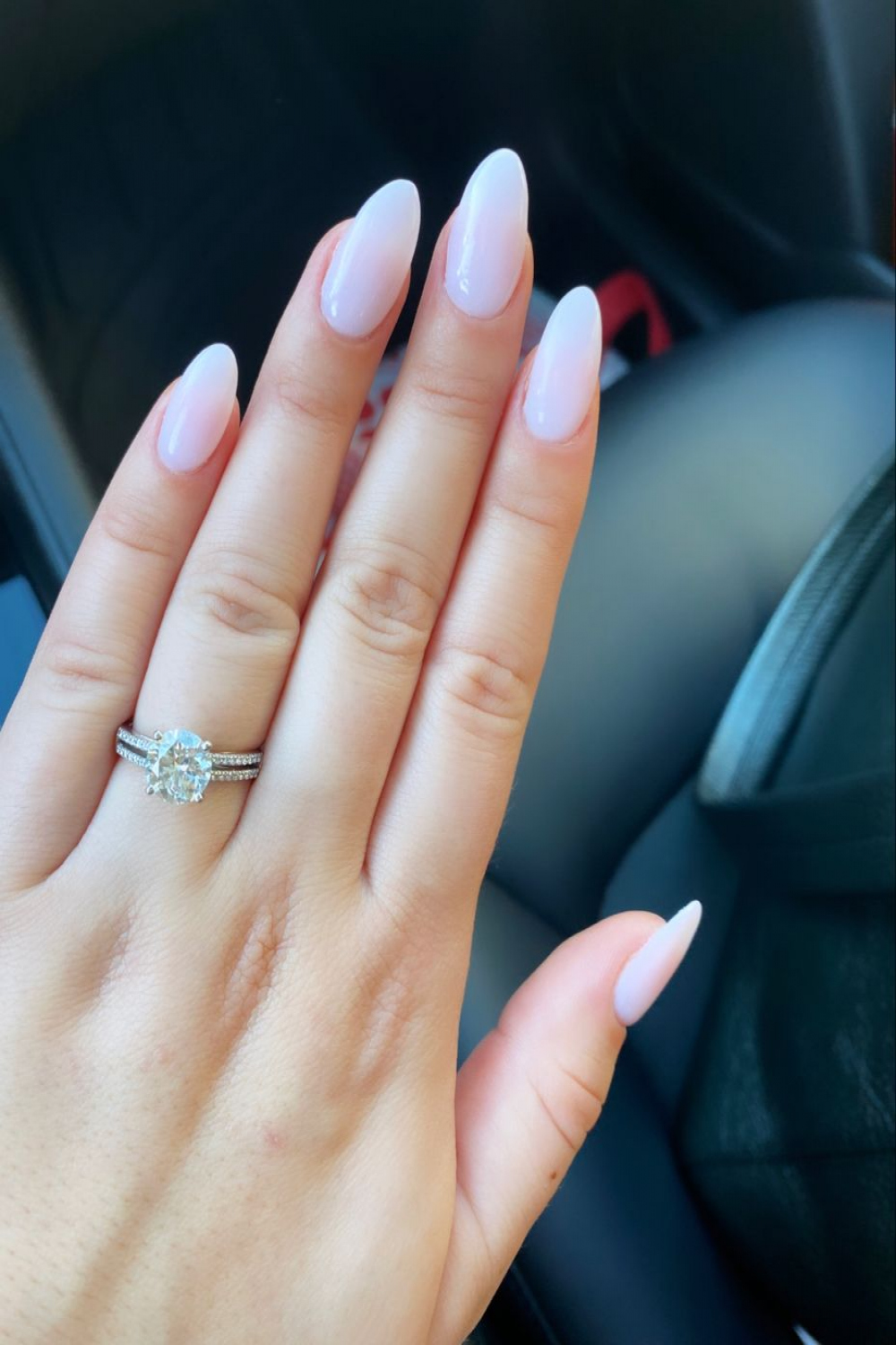 Almond shaped long nails with a very light pink color